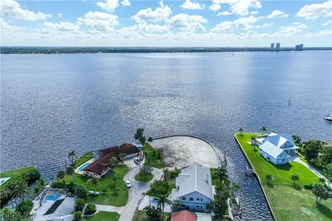 an aerial view of a house with a garden and lake view