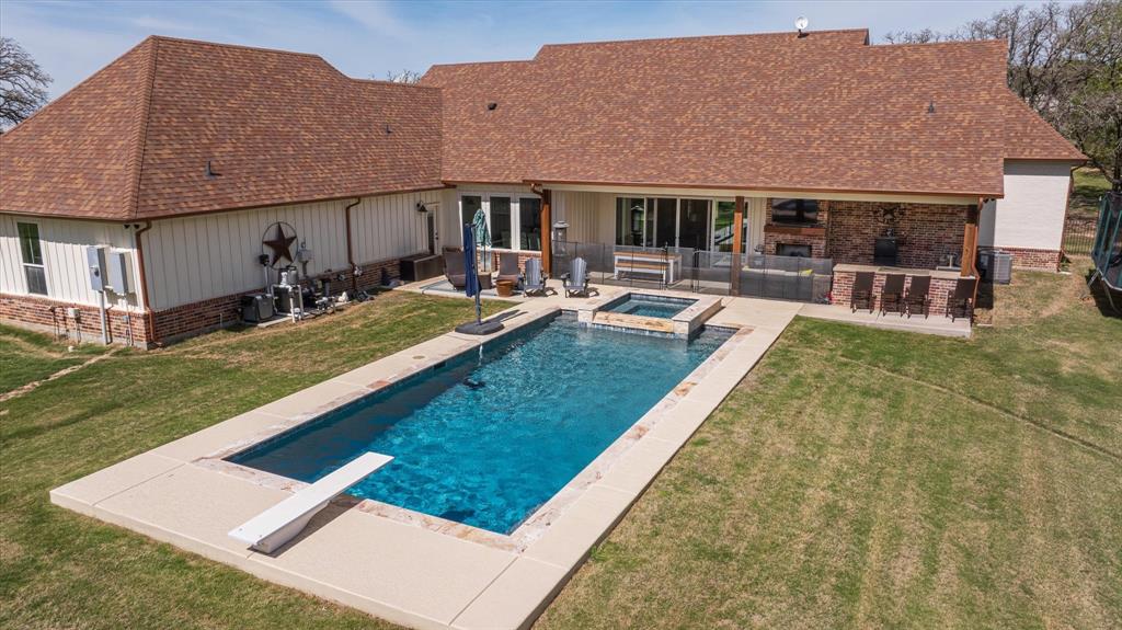 a view of house with swimming pool yard and patio
