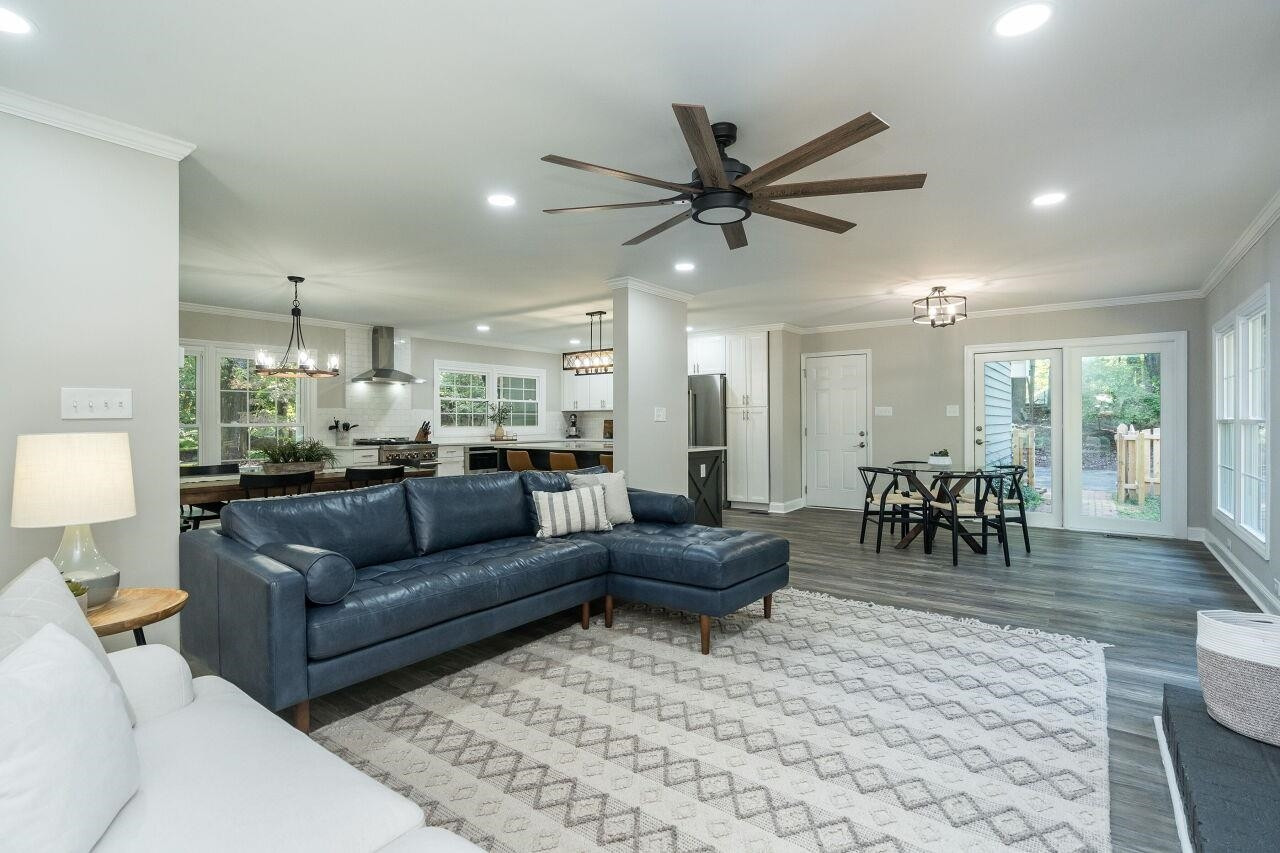 9801 Pine Meadow Lane Raleigh, NC 27615 - Photo 11 of 43 a living room with furniture and a dining table with wooden floor