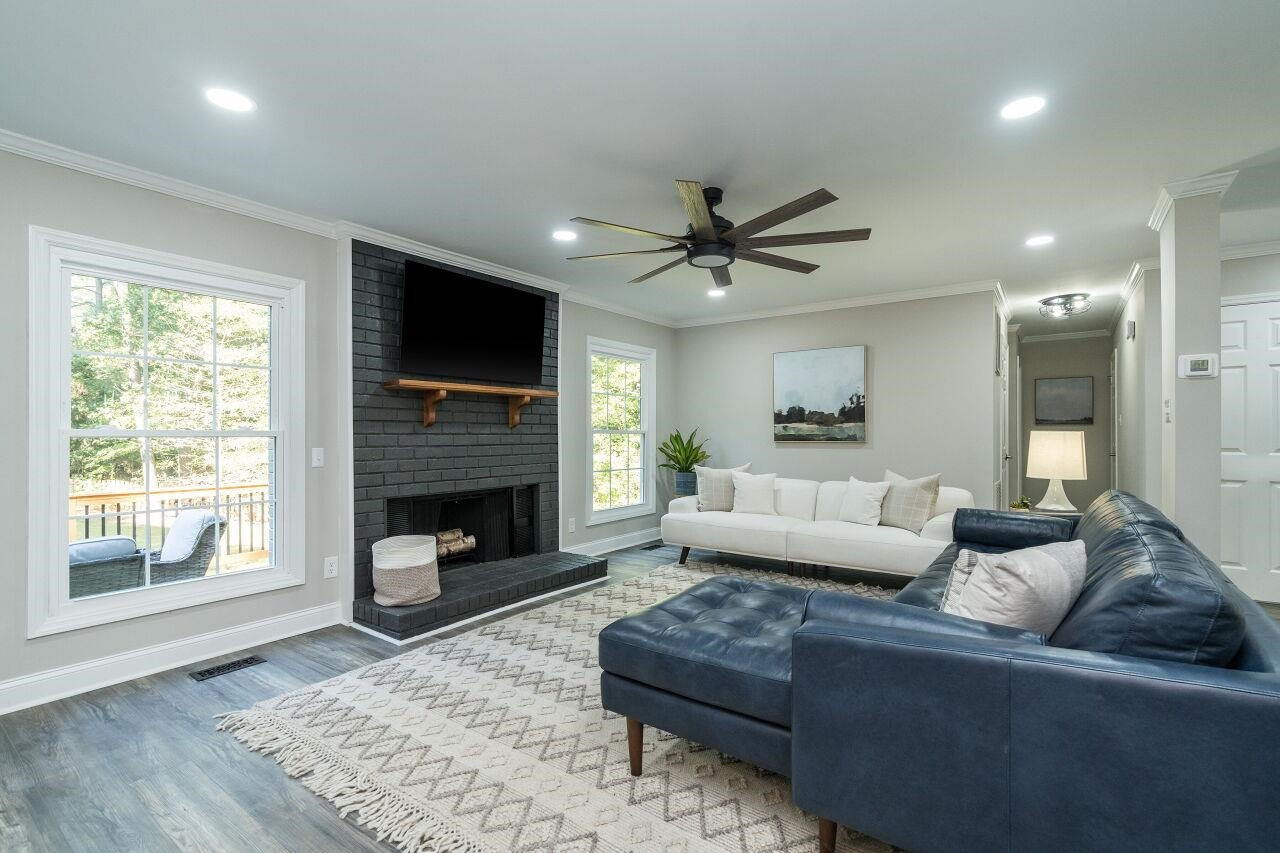 9801 Pine Meadow Lane Raleigh, NC 27615 - Photo 12 of 43 a living room with furniture a flat screen tv and a fireplace