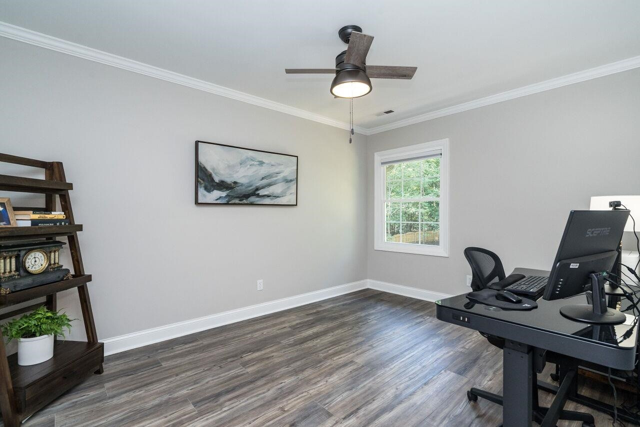 9801 Pine Meadow Lane Raleigh, NC 27615 - Photo 19 of 43 a view of a workspace with furniture and a window