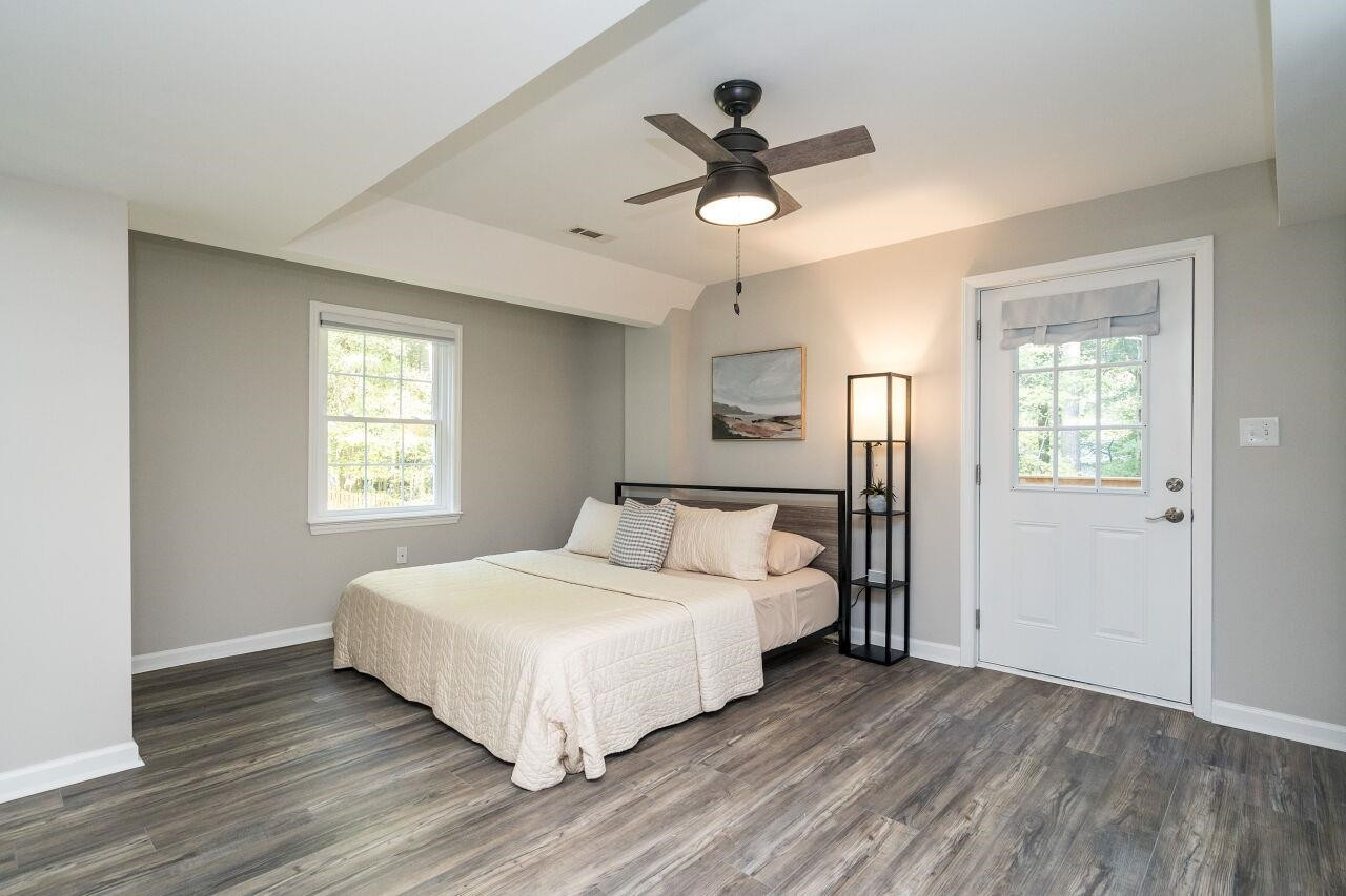 9801 Pine Meadow Lane Raleigh, NC 27615 - Photo 22 of 43 a bedroom with a large bed chandelier and a window