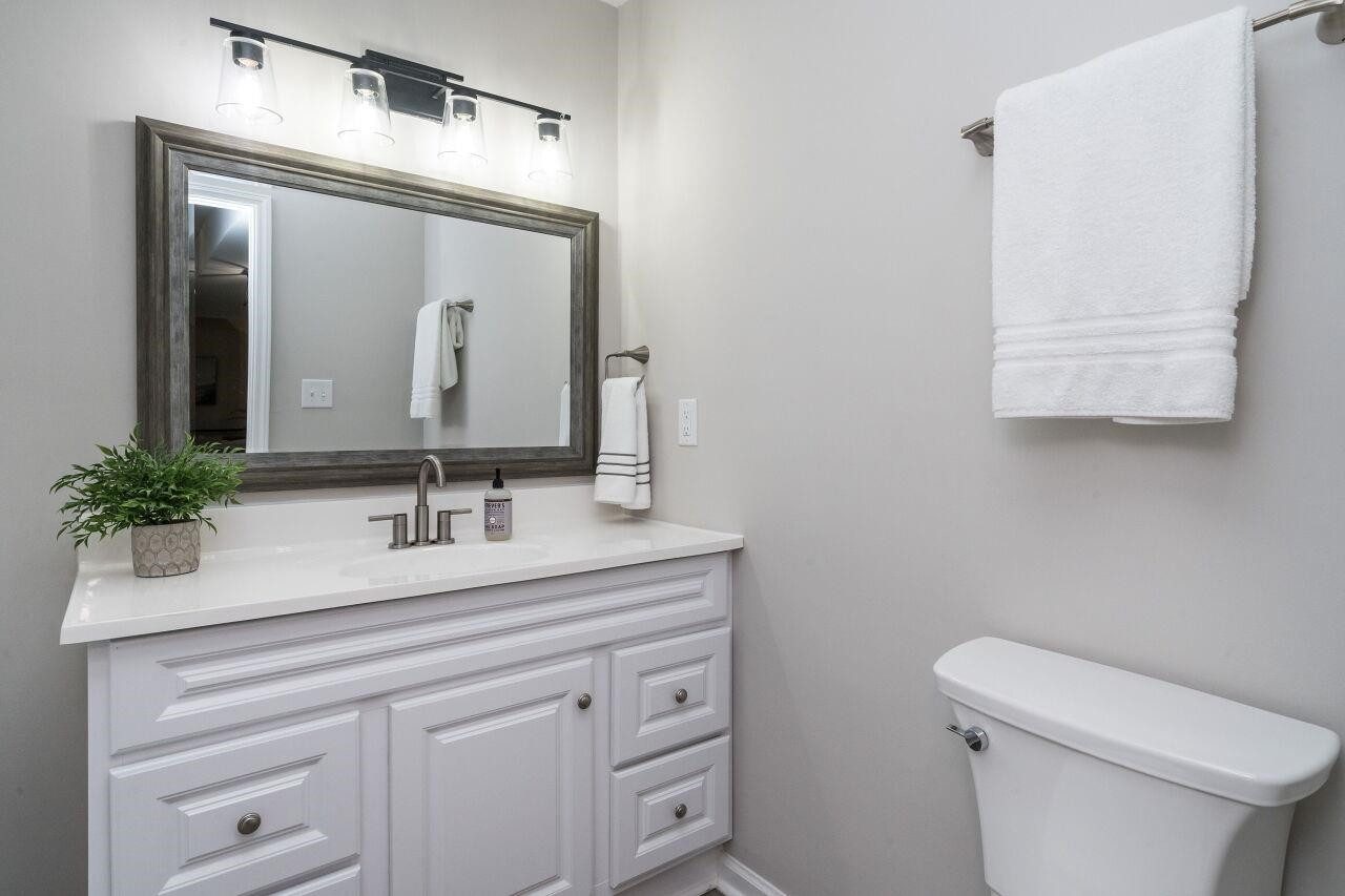 9801 Pine Meadow Lane Raleigh, NC 27615 - Photo 23 of 43 a bathroom with a toilet sink and mirror
