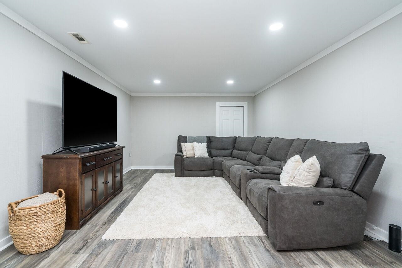 9801 Pine Meadow Lane Raleigh, NC 27615 - Photo 24 of 43 a living room with furniture and a flat screen tv