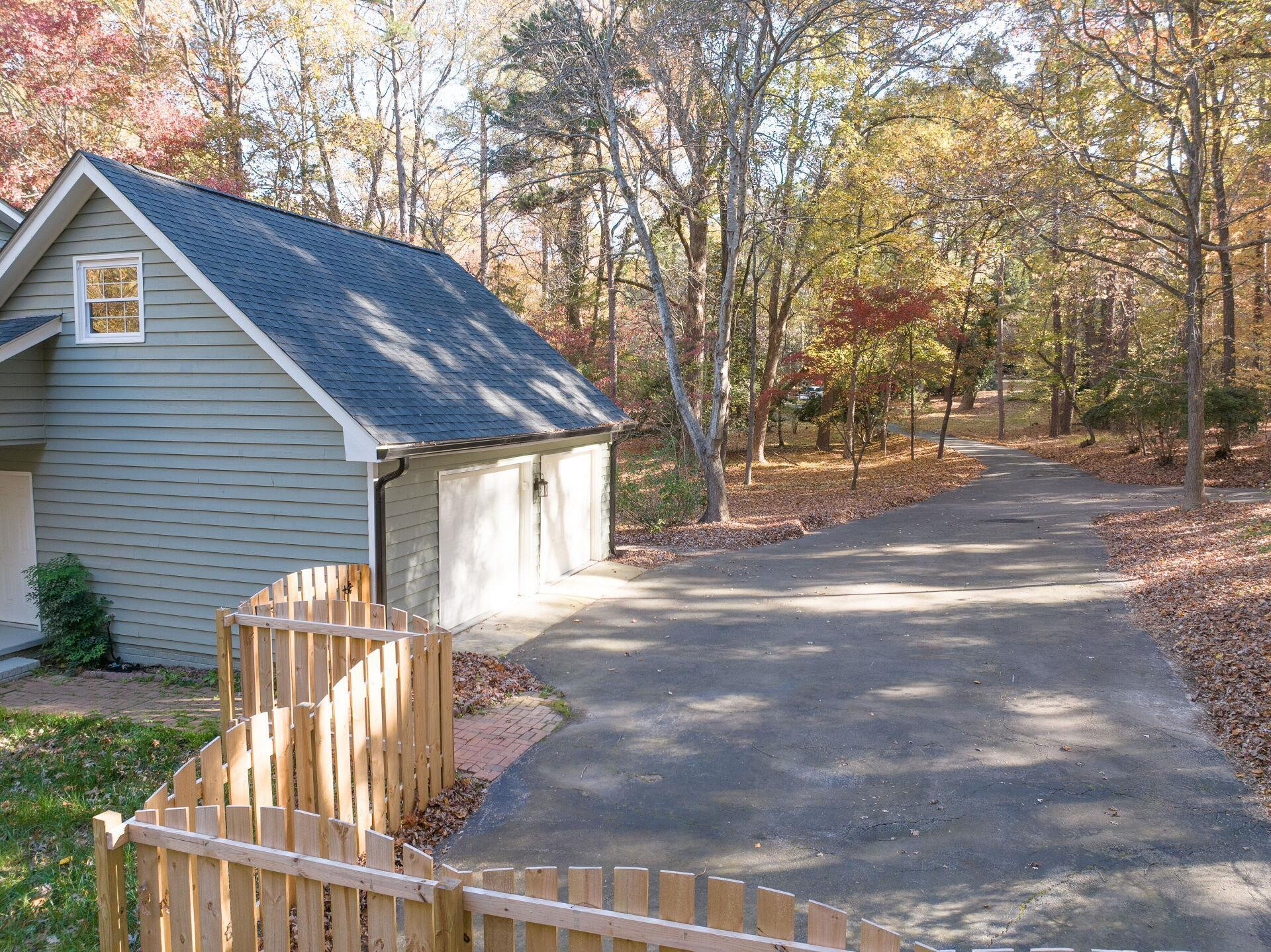 9801 Pine Meadow Lane Raleigh, NC 27615 - Photo 33 of 43 a view of a house with a yard and wooden fence