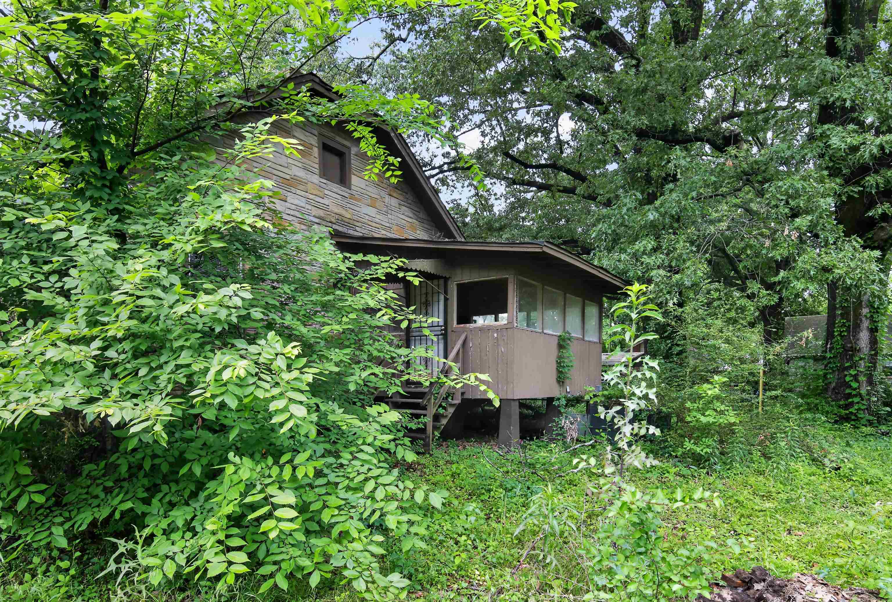 810 Hale Road Memphis, TN 38116 - Photo 3 of 30 Stone-clad exterior featuring a gabled roofline and an upper-level window