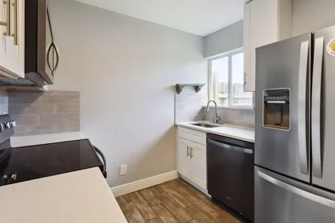 a kitchen with stainless steel appliances a refrigerator and a sink