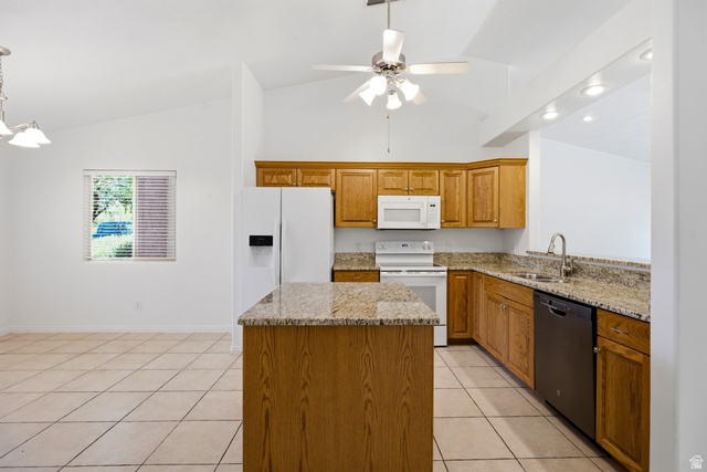 1630 East 2450th Street South, Unit 263 St. George, UT 84790 - Photo 6 of 24 Kitchen featuring a central island with a stone countertop, wood cabinetry, and integrated white appliances