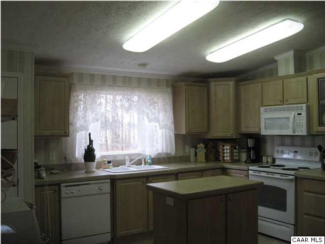 124 Deerfield Road Louisa, VA 23093 - Photo 3 of 12 a kitchen with stainless steel appliances granite countertop a sink stove and cabinets