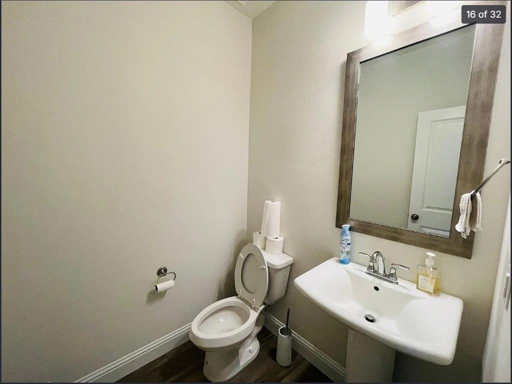 1009 Emil Place Allen, TX 75013 - Photo 16 of 31 a bathroom with a sink and mirror with toilet