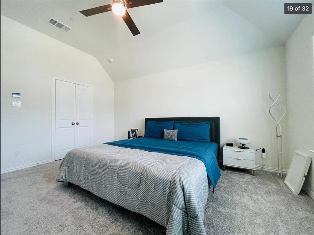 1009 Emil Place Allen, TX 75013 - Photo 18 of 31 a bedroom with a bed and a ceiling fan