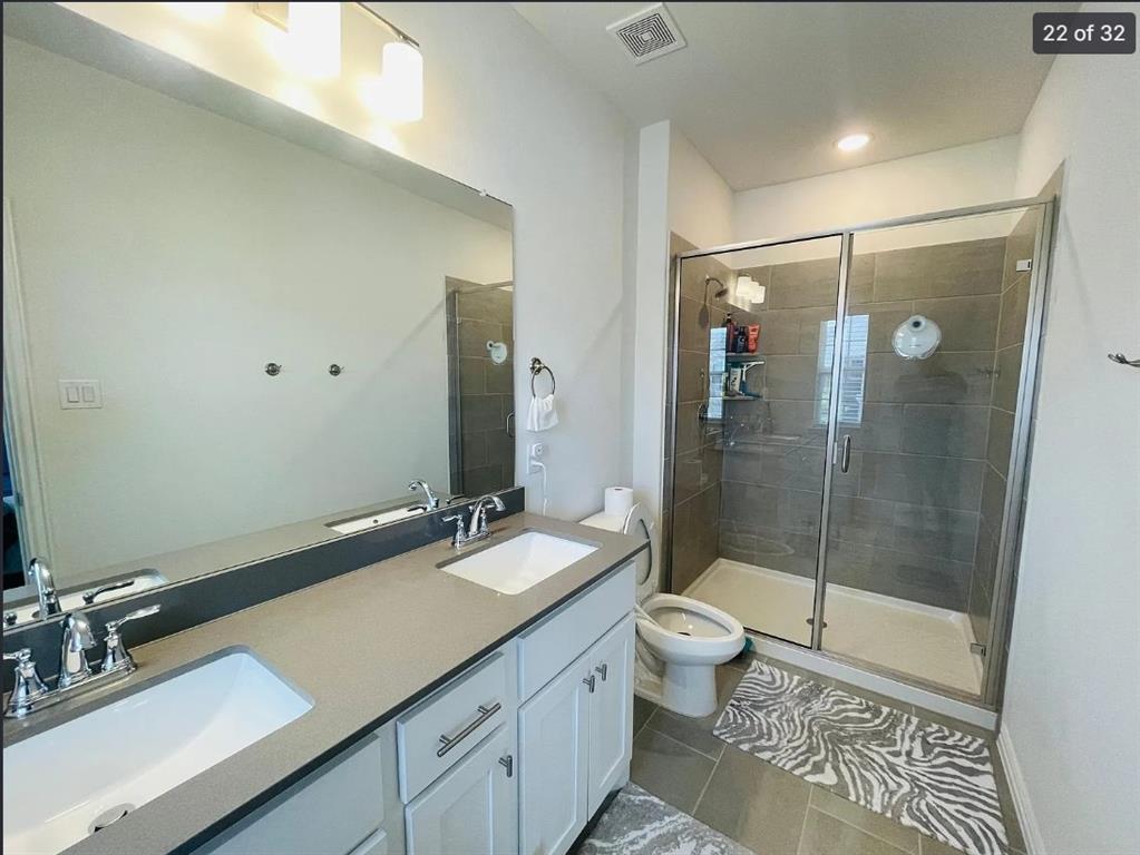 1009 Emil Place Allen, TX 75013 - Photo 21 of 31 a bathroom with a double vanity sink toilet and shower