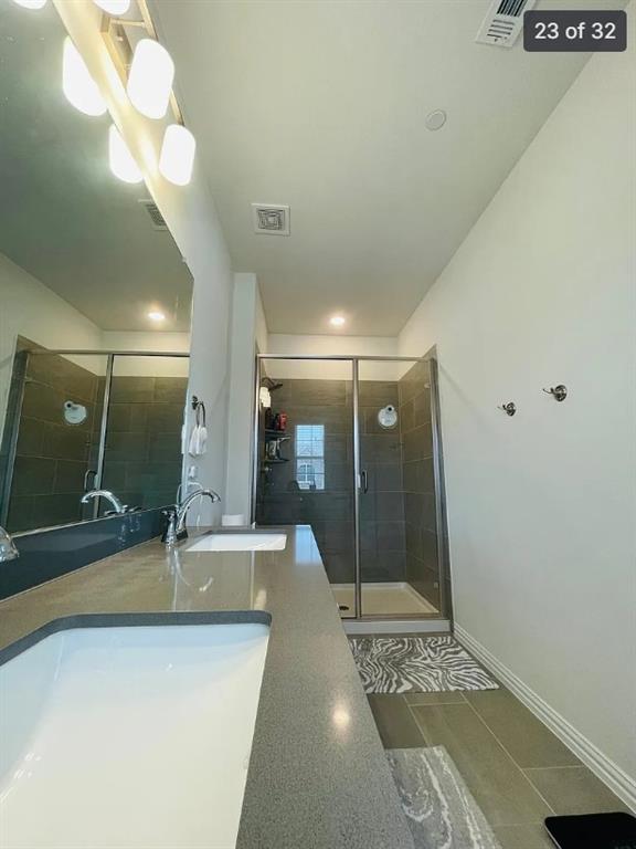 1009 Emil Place Allen, TX 75013 - Photo 22 of 31 a bathroom with a sink a toilet a mirror and shower