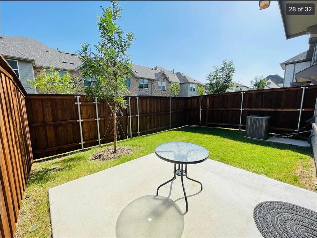 1009 Emil Place Allen, TX 75013 - Photo 27 of 31 a view of a backyard with table and chairs potted plants and wooden fence