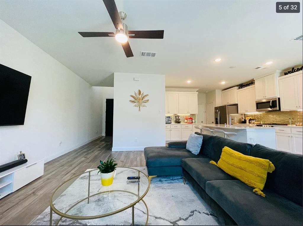 1009 Emil Place Allen, TX 75013 - Photo 6 of 31 a living room with furniture and a flat screen tv