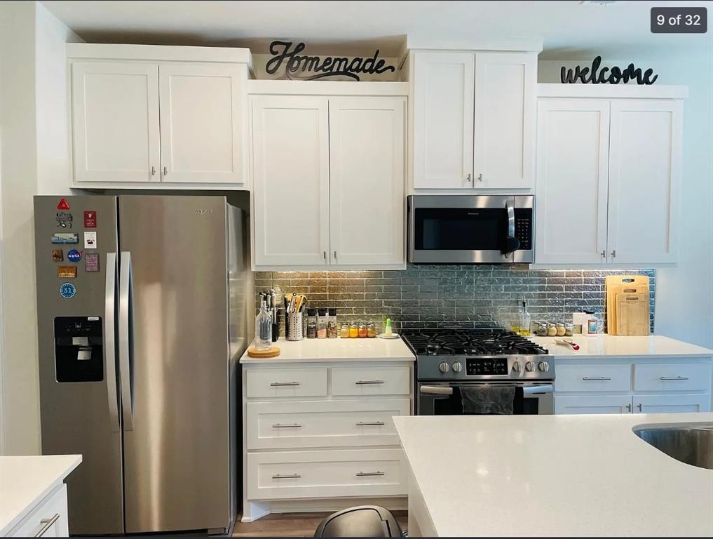 1009 Emil Place Allen, TX 75013 - Photo 9 of 31 a kitchen with stainless steel appliances a refrigerator stove and cabinets
