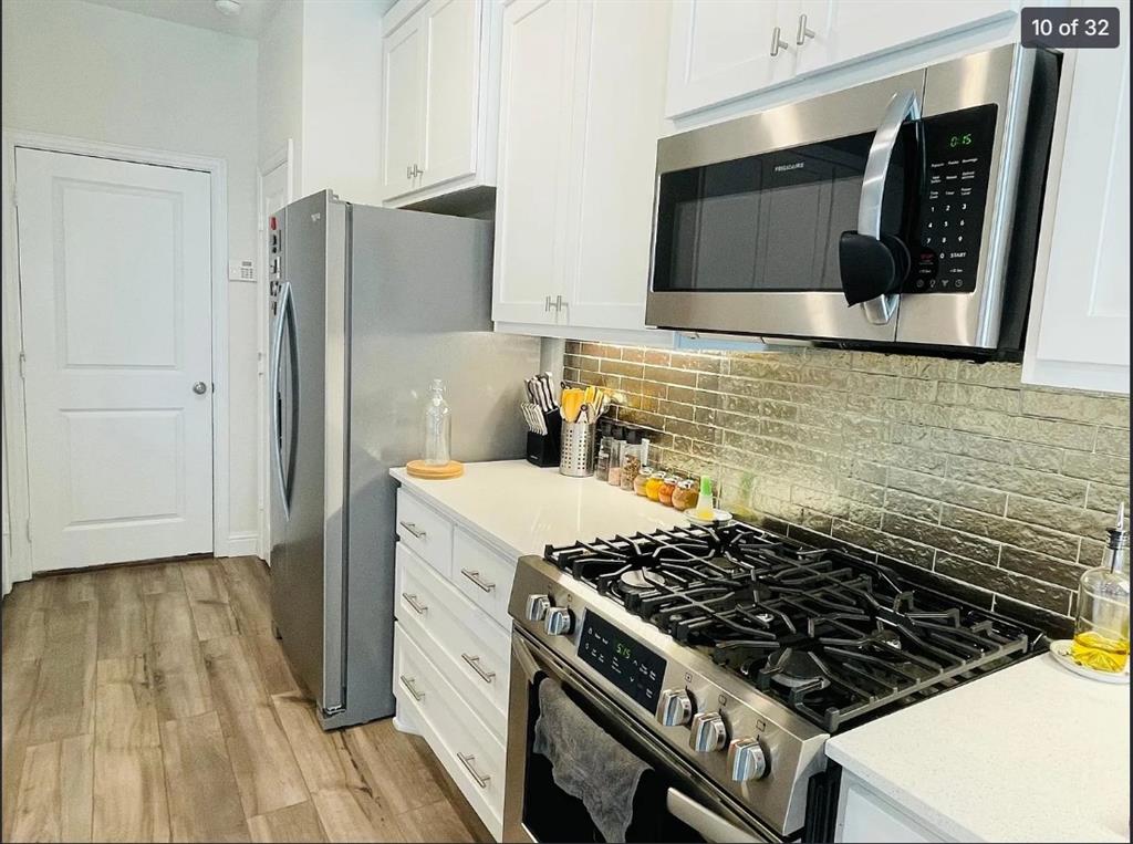 1009 Emil Place Allen, TX 75013 - Photo 10 of 31 a kitchen with granite countertop a stove and a microwave