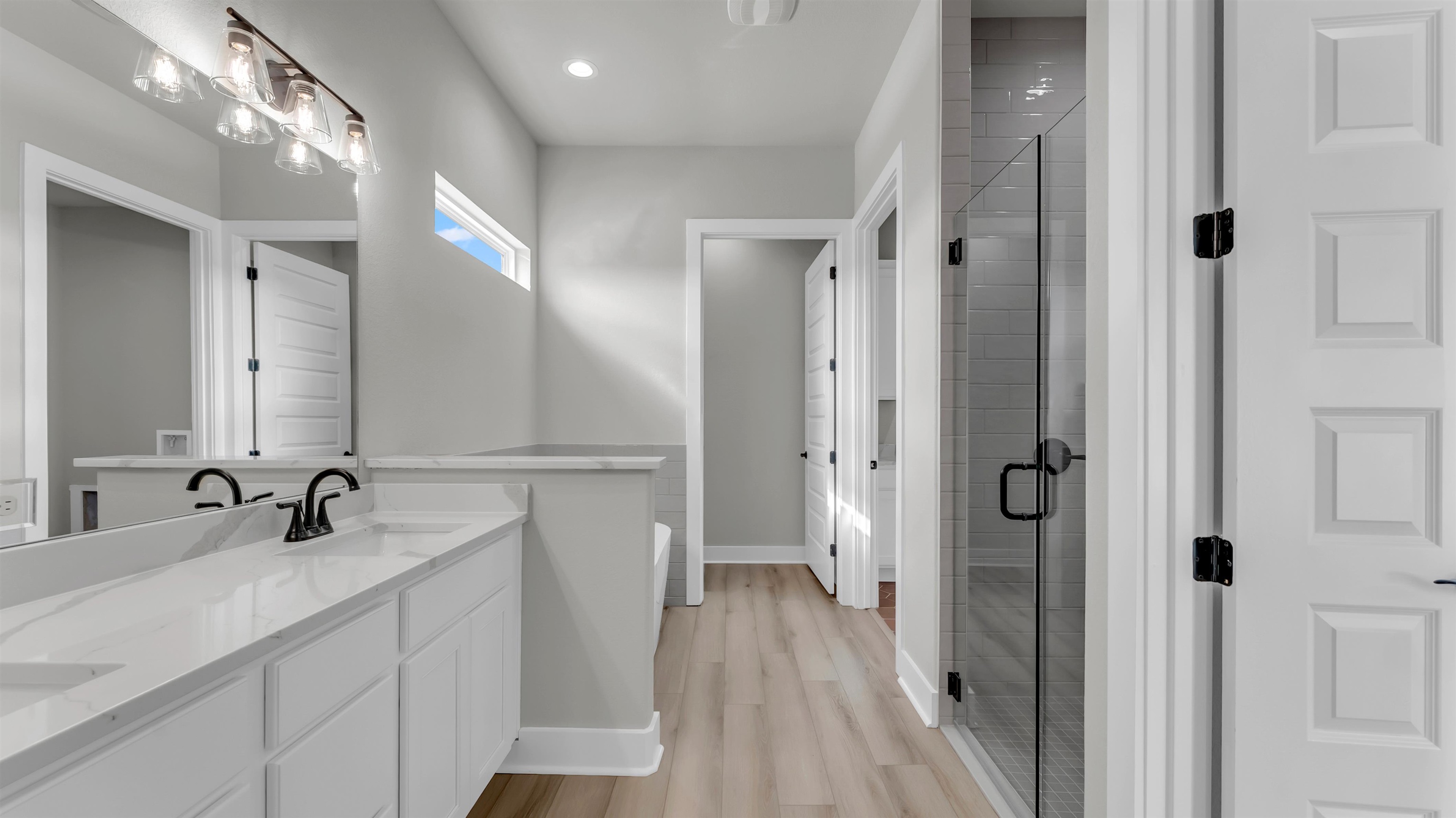 373 Prarie Point Road Bertram, TX 78605 - Photo 13 of 25 a en suite bathroom with a sink mirror and a shower