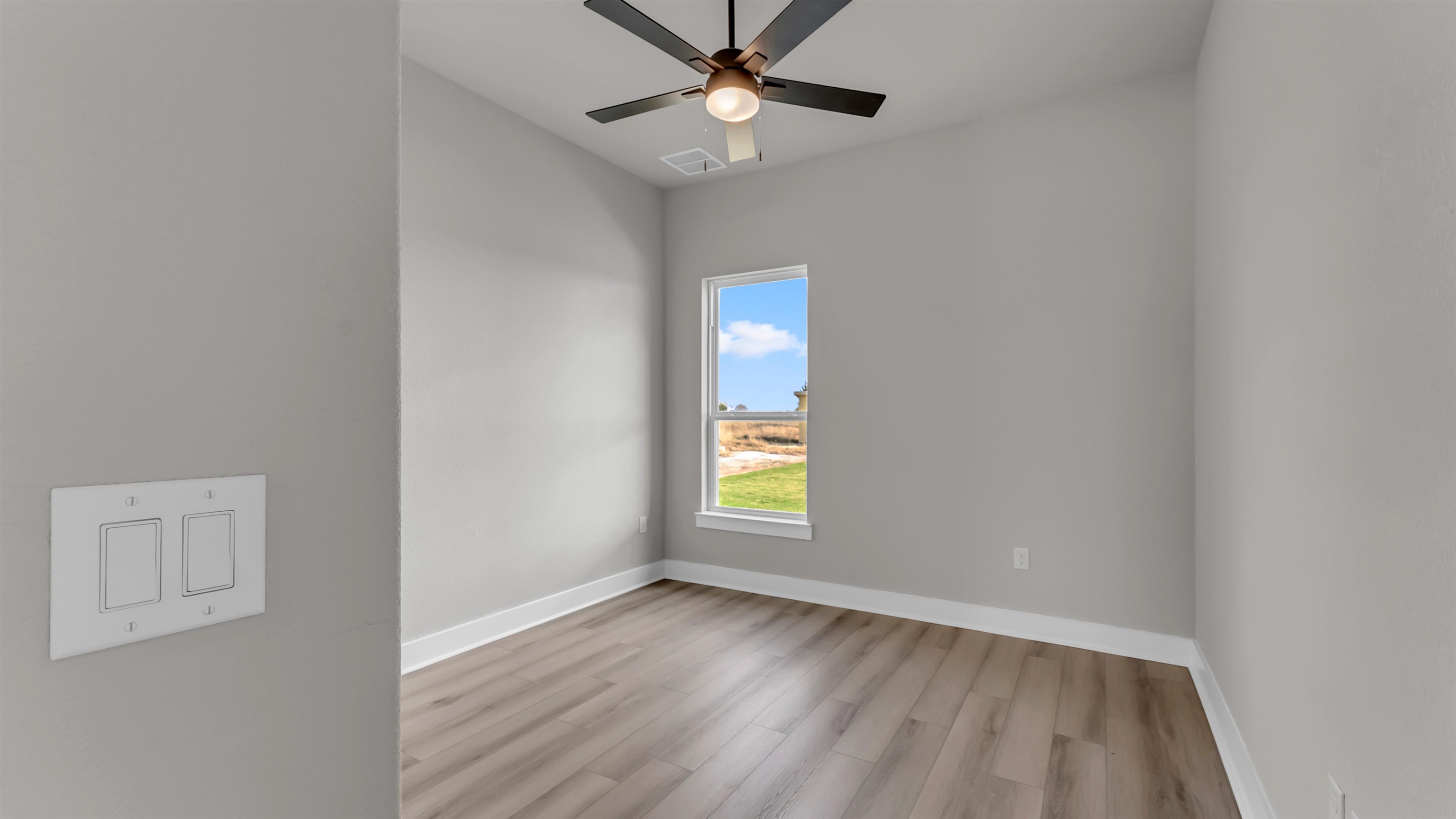373 Prarie Point Road Bertram, TX 78605 - Photo 16 of 25 wooden floor in an empty room with a window