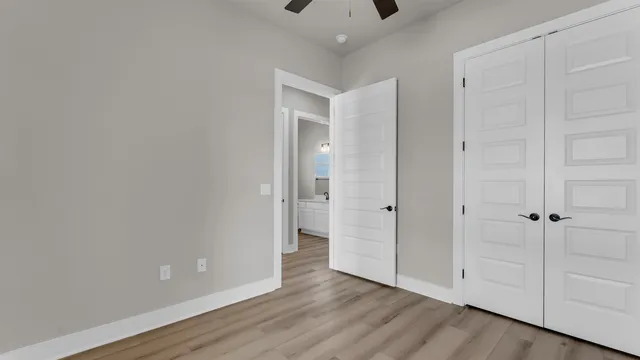 a view of an empty room with wooden floor