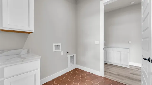 a view of storage and utility room with closet