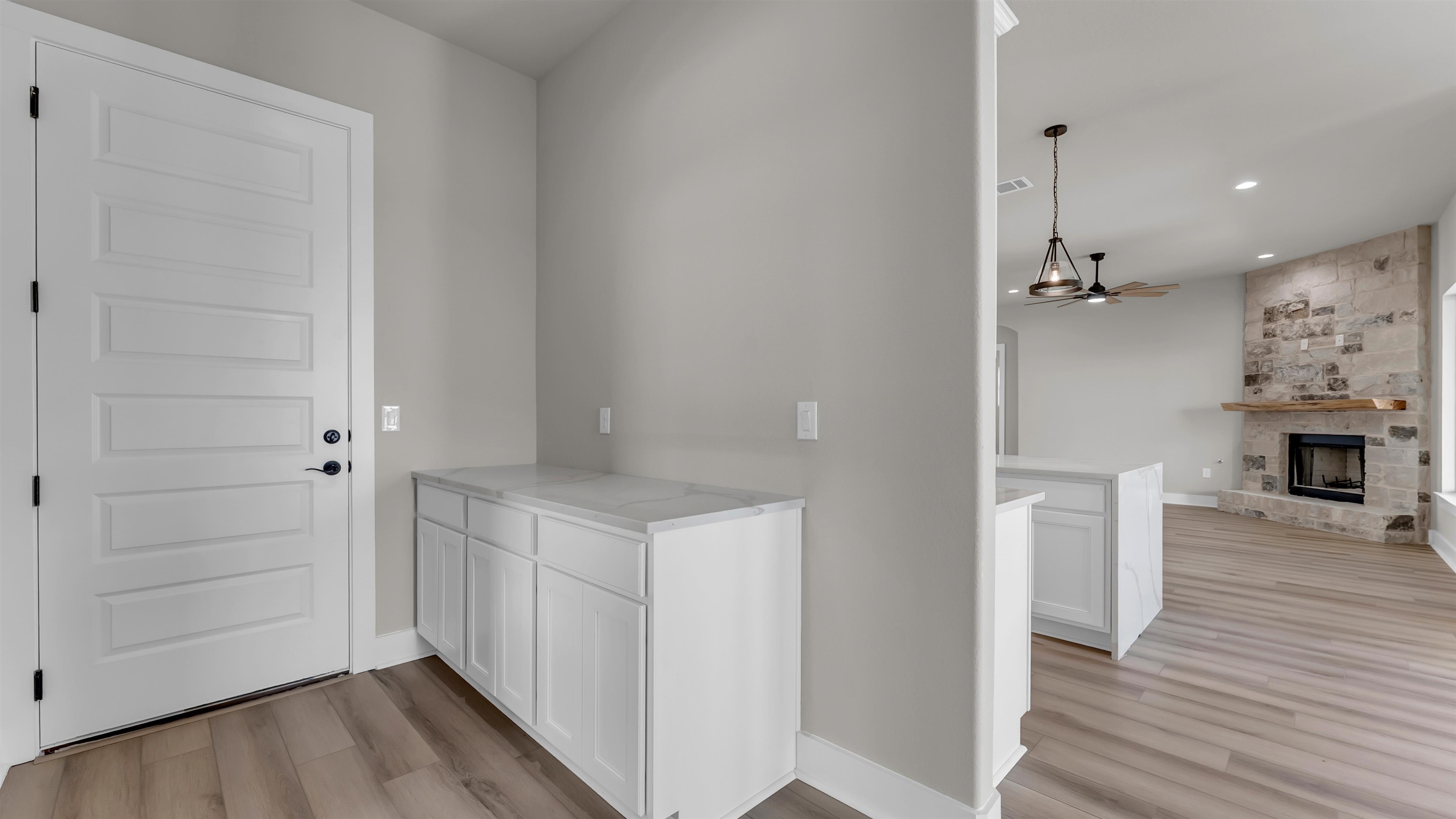 373 Prarie Point Road Bertram, TX 78605 - Photo 22 of 25 a view of a hallway with wooden floor and staircase