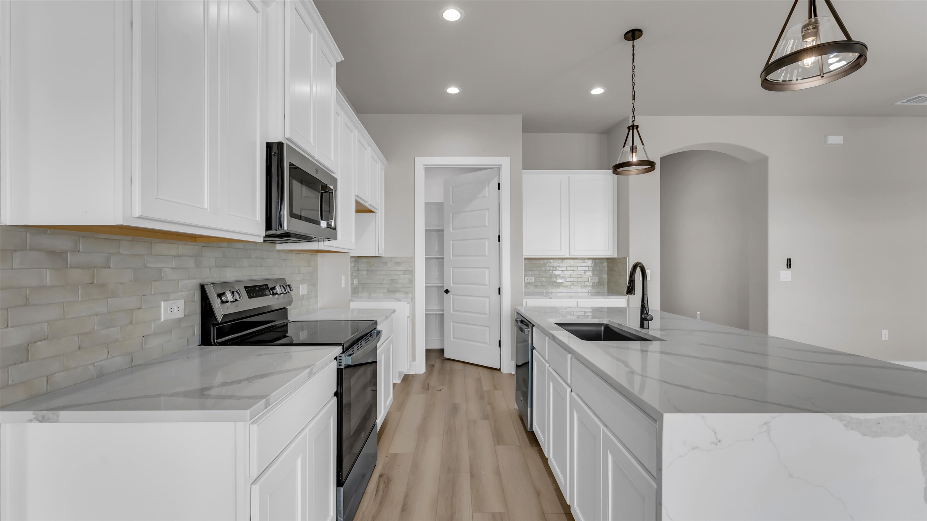 373 Prarie Point Road Bertram, TX 78605 - Photo 7 of 25 a kitchen with stainless steel appliances granite countertop a sink stove and refrigerator