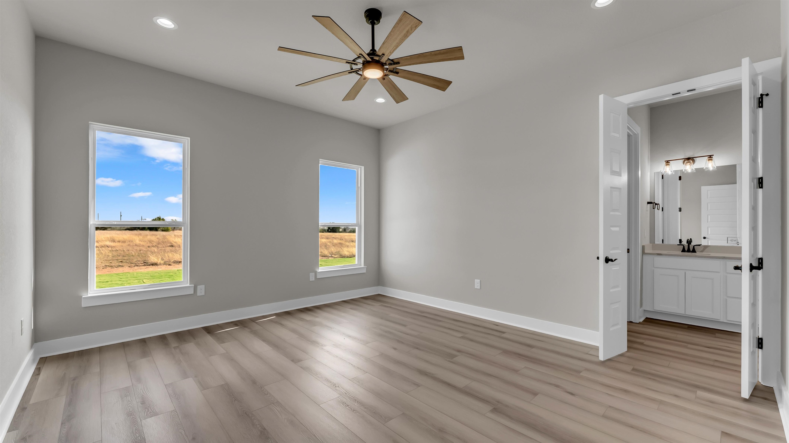 373 Prarie Point Road Bertram, TX 78605 - Photo 10 of 25 a view of an empty room with a window and wooden floor