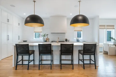a kitchen with granite countertop a table and chairs