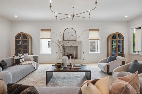 a living room with furniture a fireplace and a large window