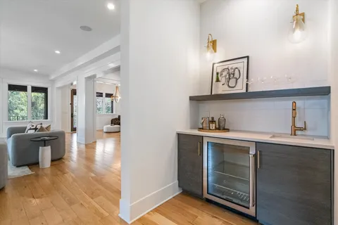a view of kitchen with sink and refrigerator