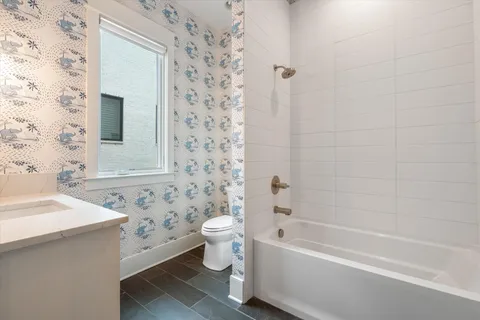 a spacious bedroom with bed and a large window