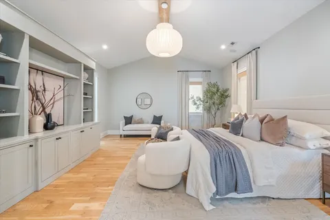 a bed room with bed and balcony with couch