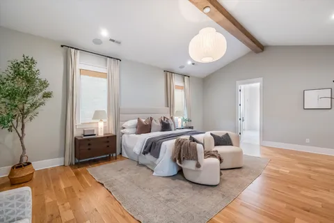 a view of a walk in closet with wooden floor