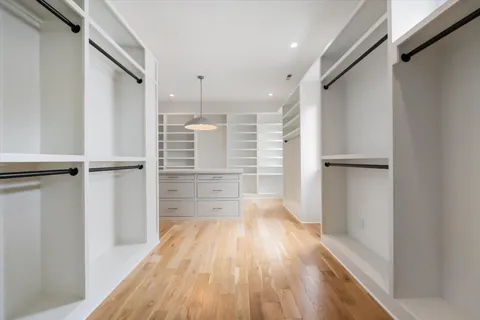 a kitchen with a white cabinets and wooden floor