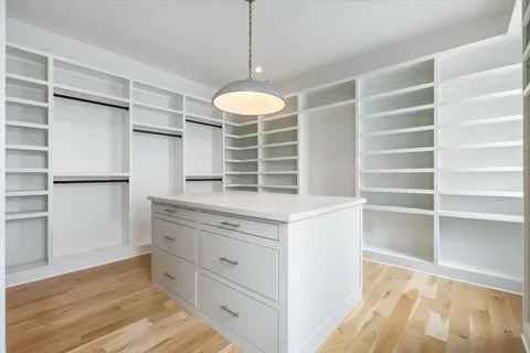 a bathroom with a double vanity sink a mirror and bathtub