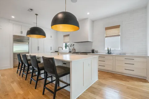 a kitchen with stainless steel appliances granite countertop a stove a sink and a refrigerator