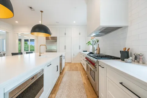 a kitchen with a stove and a sink