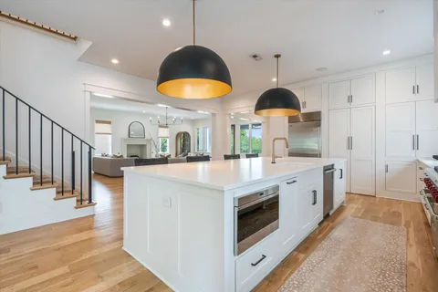 a kitchen with stove a sink and a refrigerator