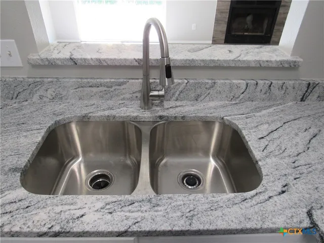 a view of a sink and granite counter top