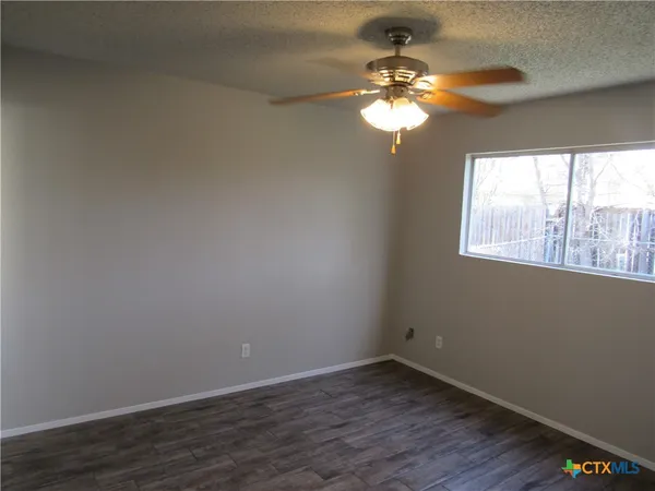 a view of a windows and chandelier fan in a room