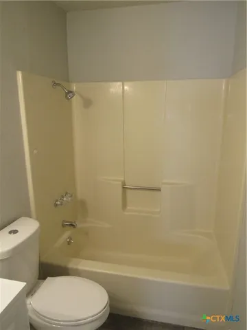 a bathroom with a toilet and shower