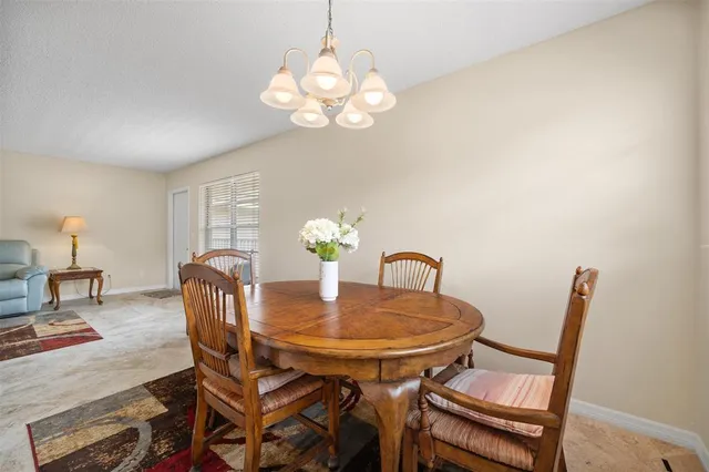 a view of a dining room with furniture and chandelier