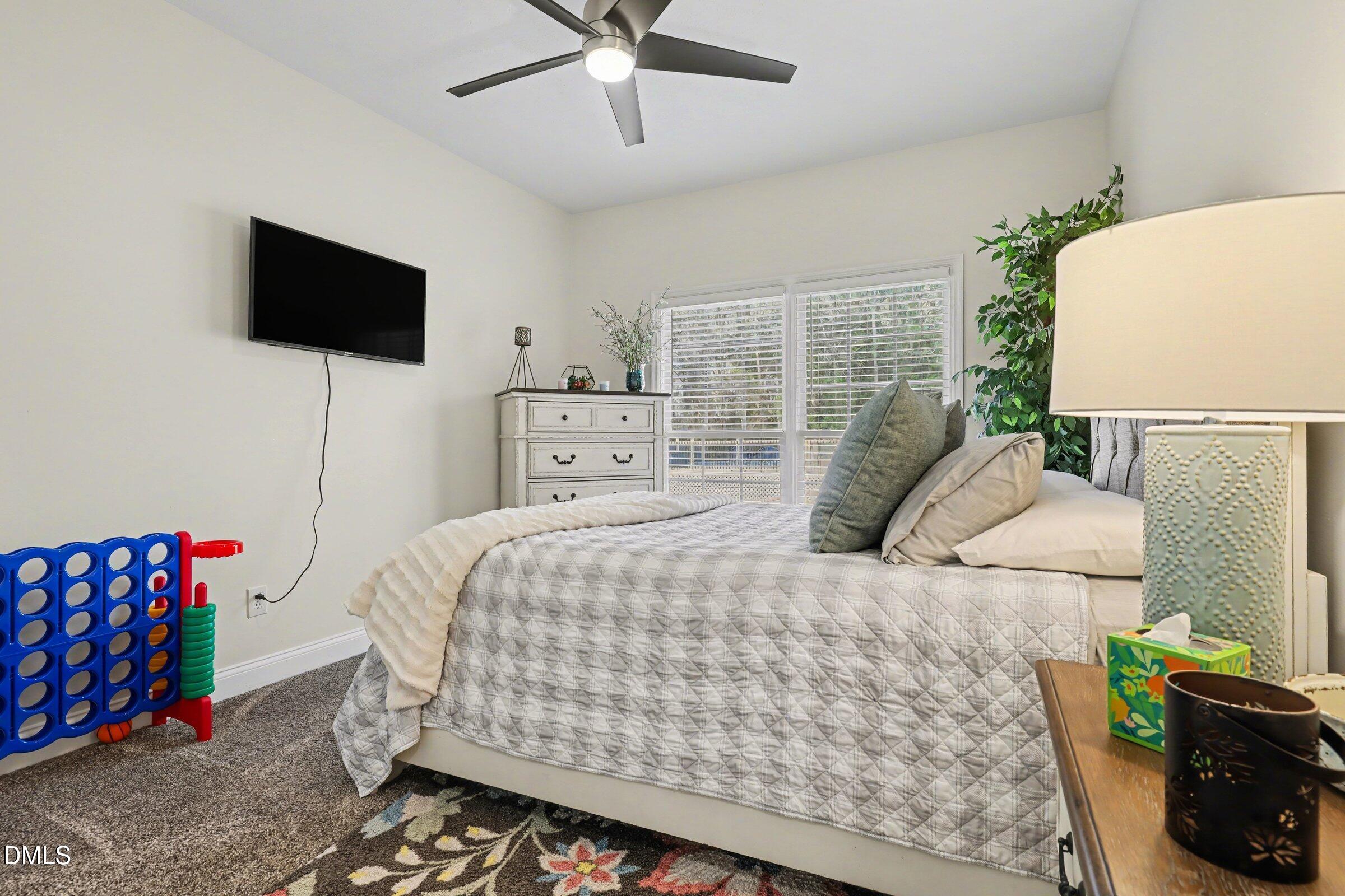 430 Fred Hall Road Stedman, NC 28391 - Photo 46 of 63 a bedroom with a bed and flat screen tv