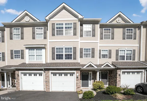 a front view of a residential apartment building with a yard