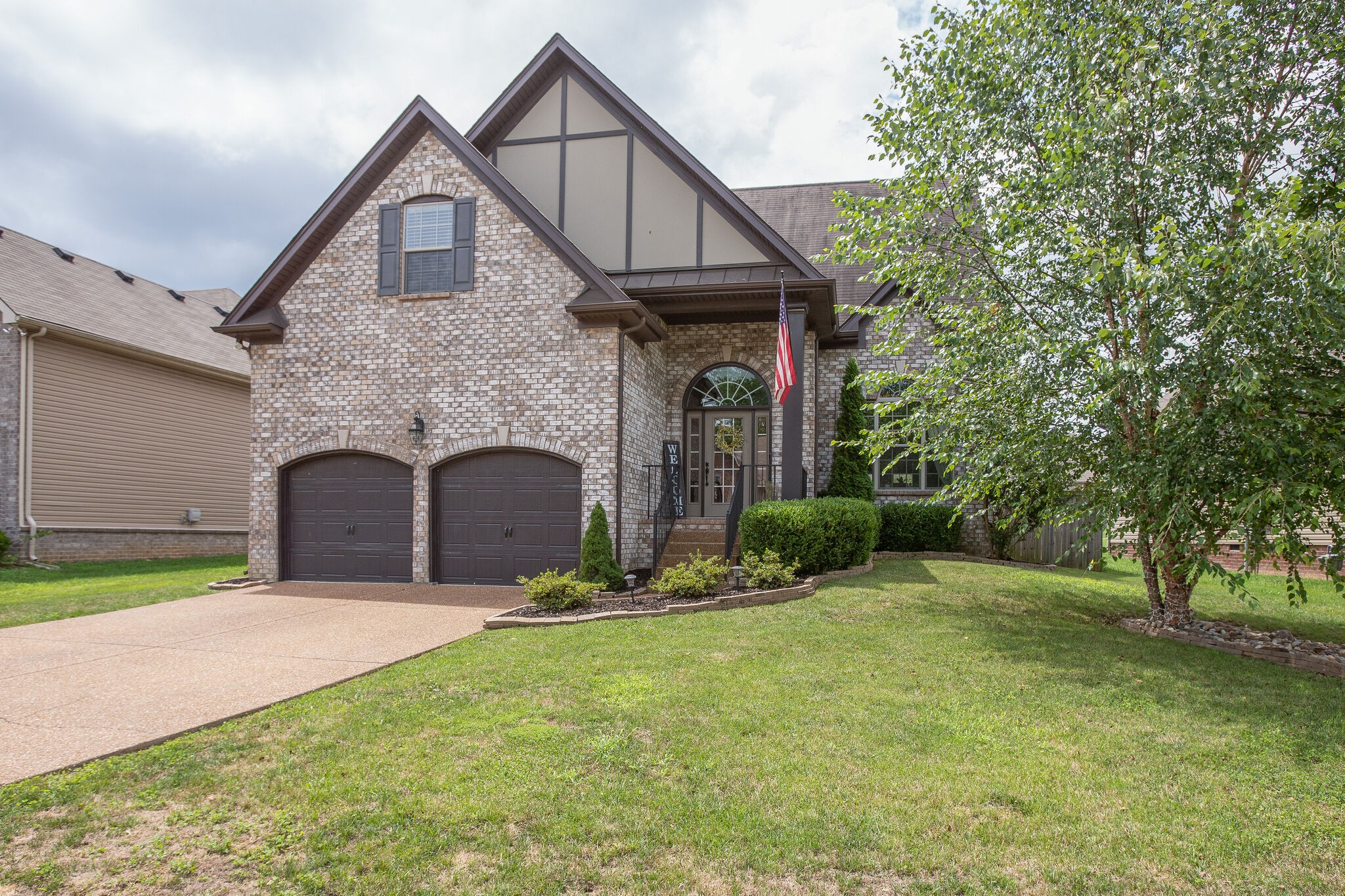 1073 Golf View Way Spring Hill, TN 37174 - Photo 2 of 34 a front view of a house with a yard and garage