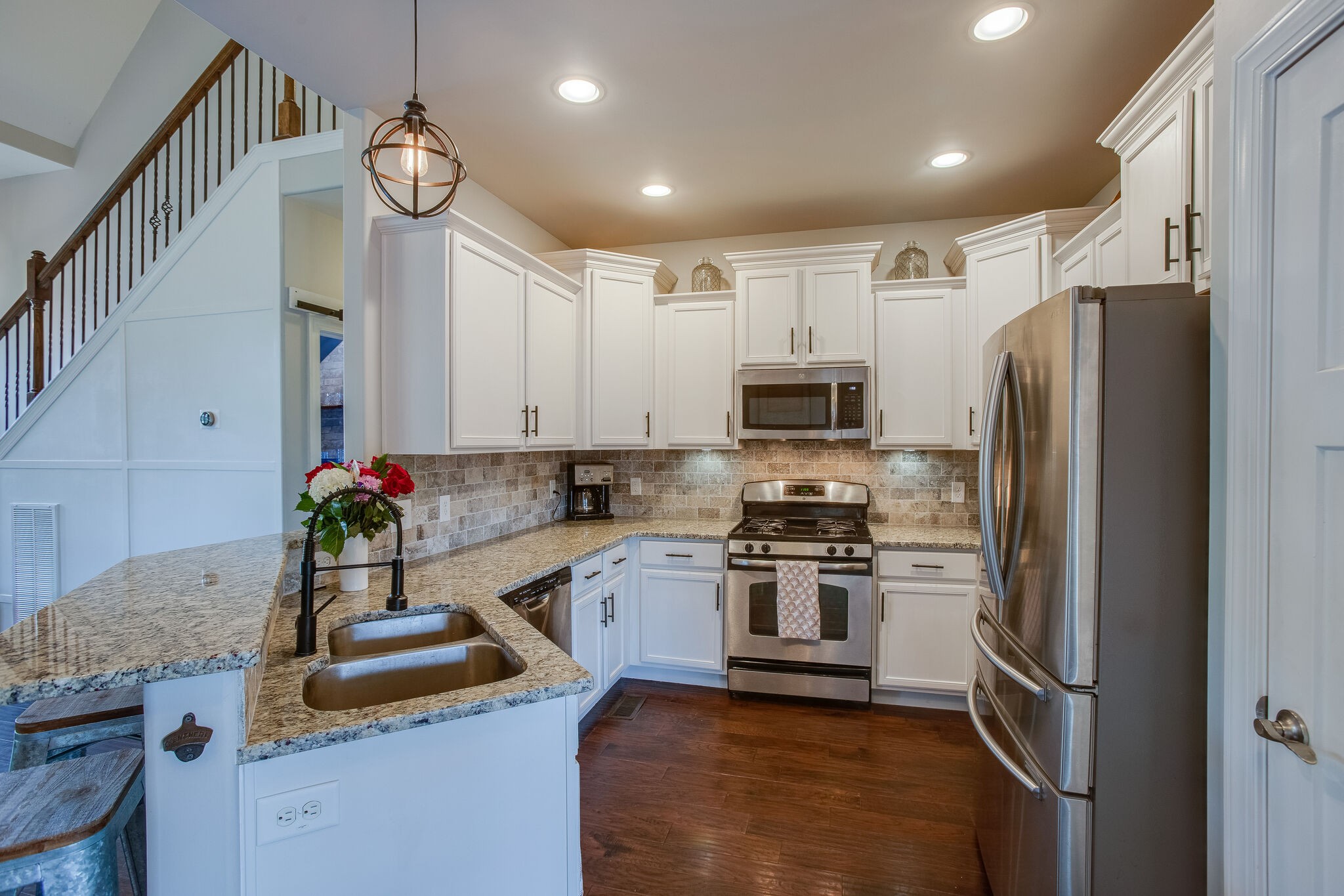 1073 Golf View Way Spring Hill, TN 37174 - Photo 12 of 34 a kitchen with kitchen island granite countertop a sink stainless steel appliances and cabinets