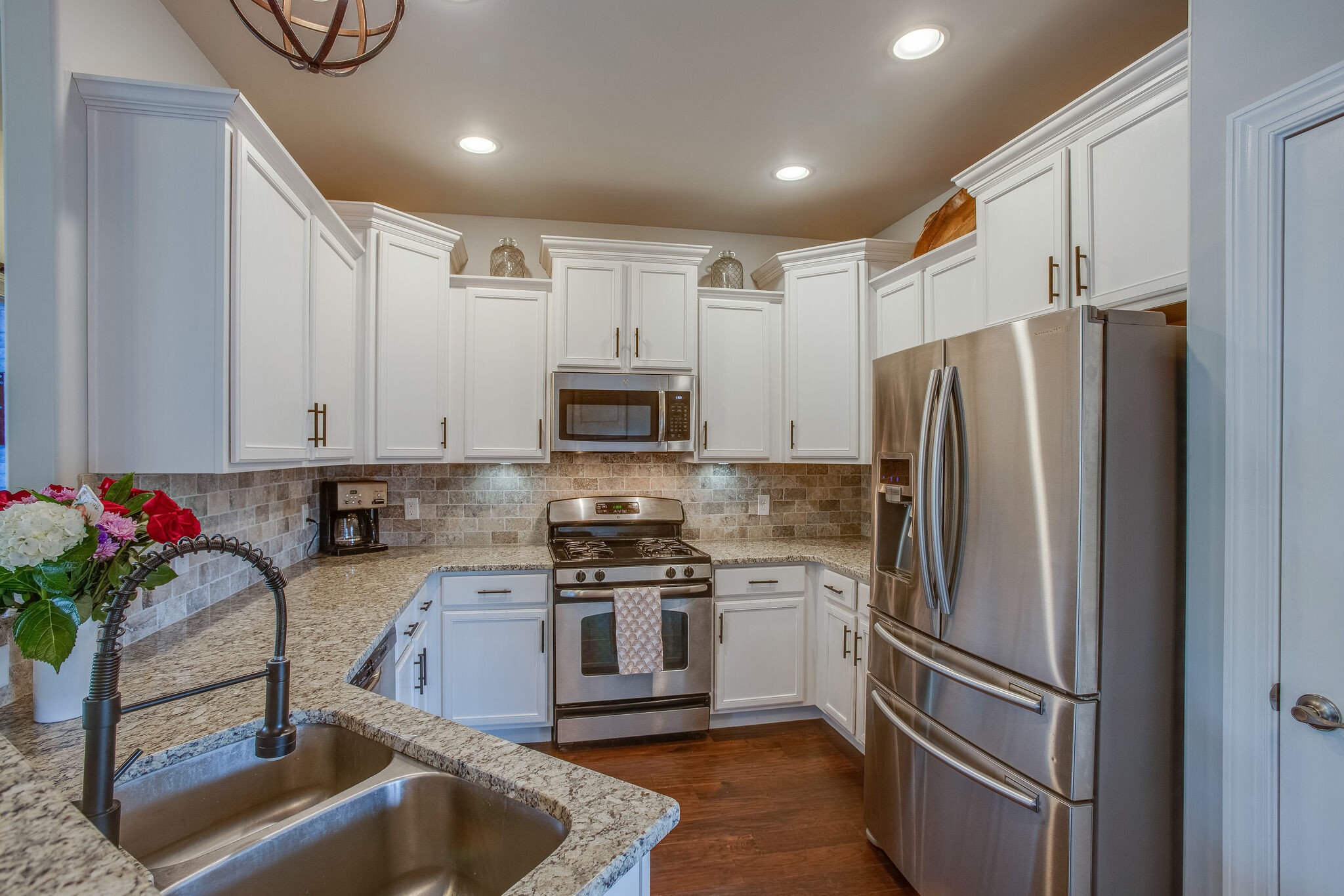 1073 Golf View Way Spring Hill, TN 37174 - Photo 13 of 34 a kitchen with stainless steel appliances granite countertop a refrigerator sink and stove