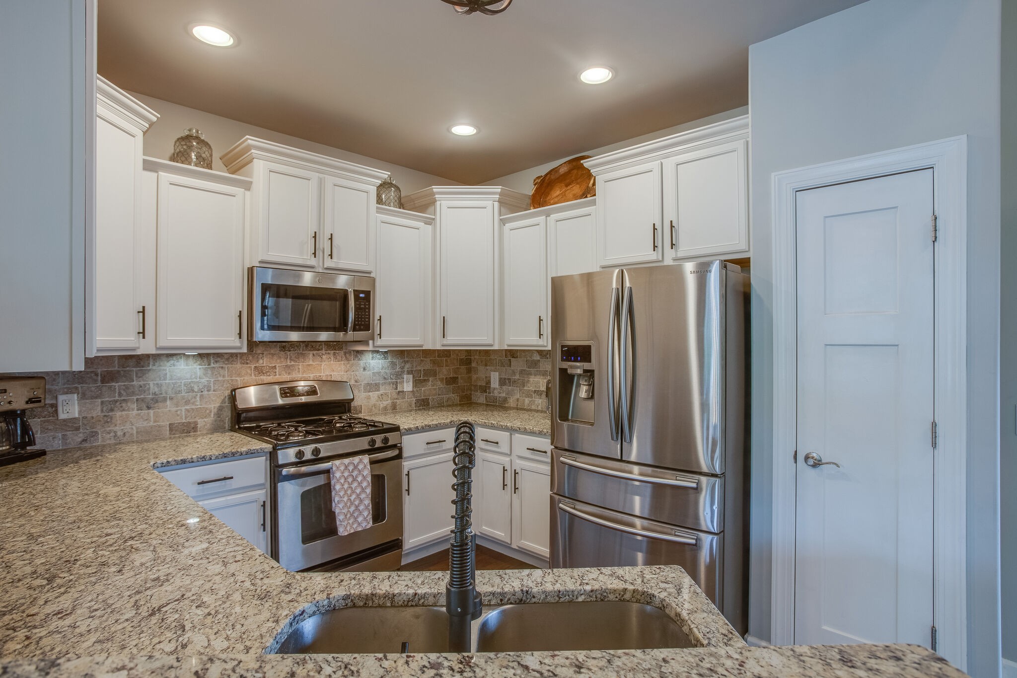 1073 Golf View Way Spring Hill, TN 37174 - Photo 14 of 34 a kitchen with stainless steel appliances granite countertop a refrigerator and a stove top oven
