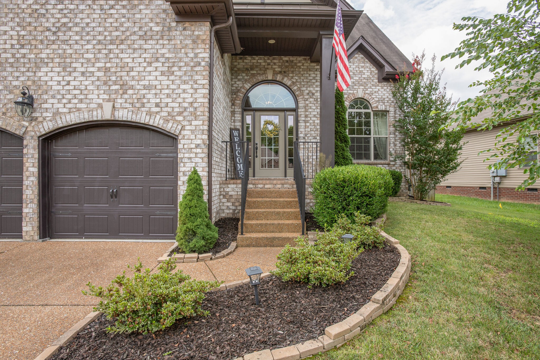 1073 Golf View Way Spring Hill, TN 37174 - Photo 3 of 34 a front view of a house with garden